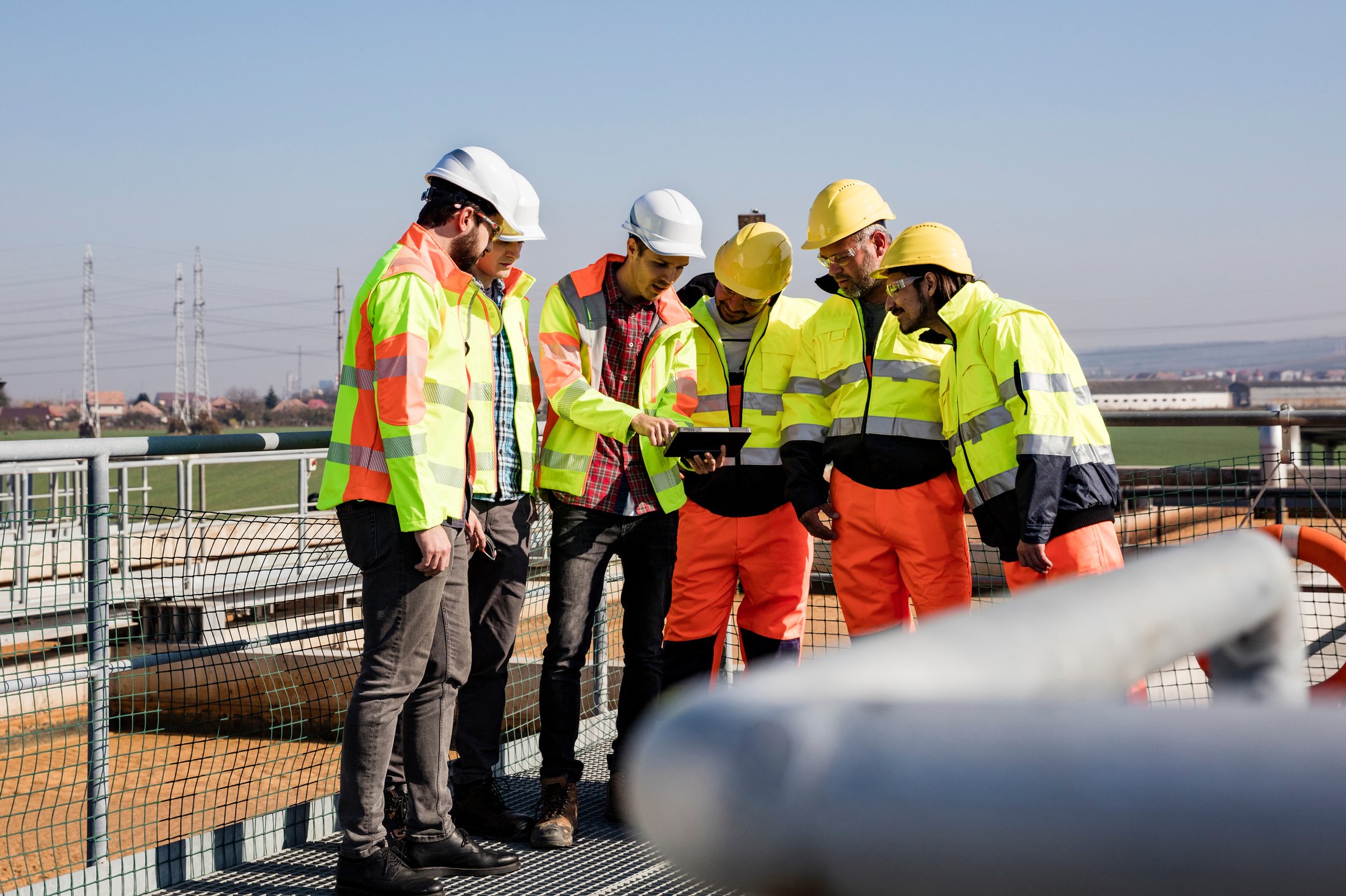 Engineers and Workers Assesing Wastewater Plant